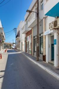 an empty street in a town with buildings at La isla in Naxos Chora