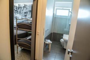 a room with a bathroom with a bed and a toilet at Hotel Hollywood Convenzionato Aquafan in Riccione +58 photos
