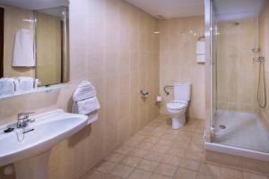 
a bathroom with a toilet, sink and shower at Hotel Catalunya Express in Tarragona
