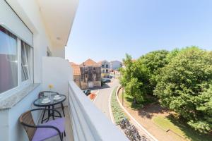 a balcony with a table and chairs and a street at Sobe Mateša in Vodice +33 photos