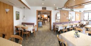 a restaurant with tables and chairs in a room at Gasthof Richebächli in Elzach