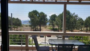 a view from a window of a table and chairs at Belvedere Κeramoti in Keramotí