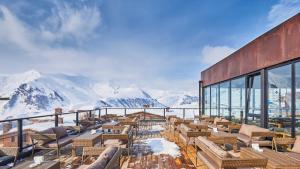 a balcony with chairs and a view of mountains at Apartment N318 Gudauri Loft in Gudauri