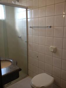 a bathroom with a shower and a toilet and a sink at Hotel Central in Porto Velho