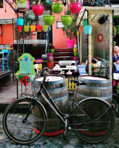 a bike parked next to two wine barrels at Imperia Apartments in Belgrade