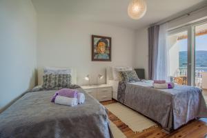 a bedroom with two beds and a window at Apartment Sara - Cres in Cres +31 photos