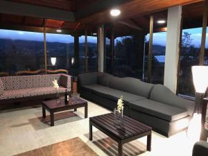 a living room with a couch and two tables at Chalet la Bonita in El Encano
