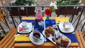 a table with plates of bread and coffee on it at Casa Dolce Casa in Pienza