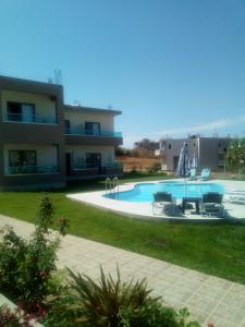 a large swimming pool in front of a building at Efrilias Studios & Apartments in Kissamos