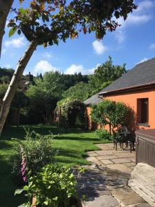 a view of a yard with a house at Ty Carreg Fach Staycation Cottage Cardiff in Cardiff