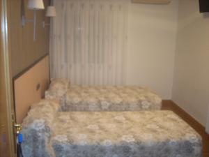 Postel nebo postele na pokoji v ubytování Hotel Corona de Castilla