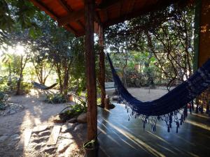 a hammock in the shade of a pavilion at Chalé Chapada dos Veadeiros in Cavalcante