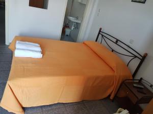 A bed or beds in a room at Efstathiou Mihail Studios and Apartments