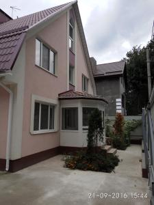 a house with a parking lot in front of it at Guest House Orchid in Kropyvnytskyi