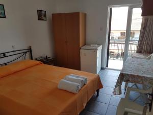 A bed or beds in a room at Efstathiou Mihail Studios and Apartments