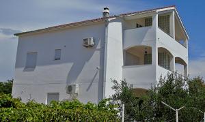 a white building with a window on the side of it at Apartments Purkovic in Vodice