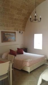 a bedroom with a large bed in a room at Corte Della Luna in Acquarica del Capo