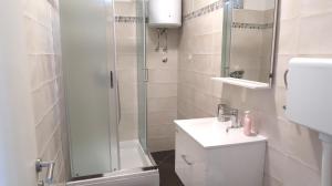 a bathroom with a shower and a toilet and a sink at Apartment Maja in Krk