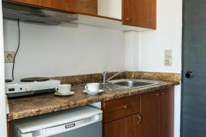 a kitchen with a sink and two cups on a counter at Laganas Dreams 2 in Laganas