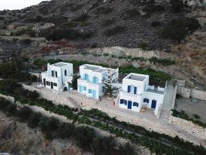 an aerial view of a cluster of white buildings on a hill at Blue Bliss in Ambrami