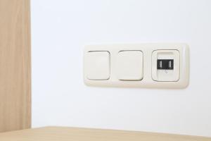 a white lightswitch on a white wall in a room at Hotel Kannenkeller in Lauingen