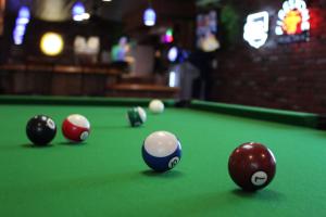 a group of billiard balls on a pool table at O'Cairns Inn and Suites in Lompoc