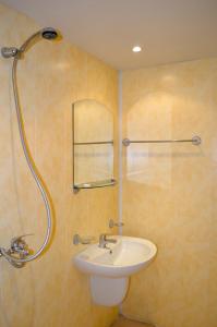 a bathroom with a sink and a shower at Hotel Romantika in Varna City +51 photos