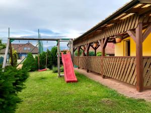 a red slide on the side of a house at Guest House Maxim in Liptovský Mikuláš