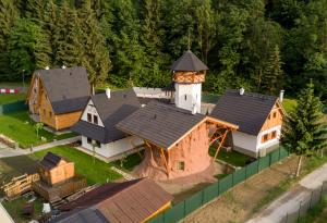 an aerial view of a large house with a clock tower at Rozprávková dedinka in Dolný Kubín