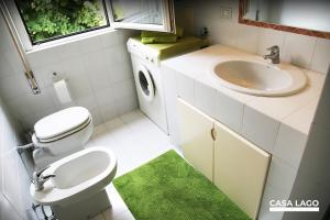 a bathroom with a toilet and a sink at CasaLago di Erika e Antonella in Pisogne