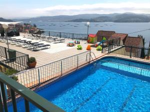 a swimming pool on a balcony with a view of the water at Apartamentos Park Raxo in Raxo