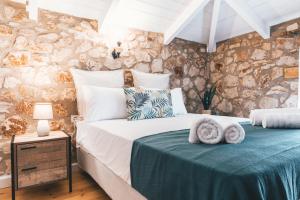 a bedroom with a bed with towels on it at Villa Dimitris in Laganas