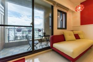 a living room with a couch and a balcony at Pure B&B in Hualien City