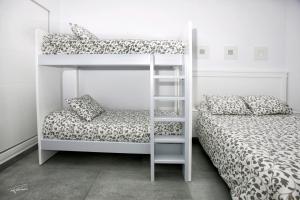 a bedroom with two bunk beds and a ladder at La Pandorga in Sanlúcar de Barrameda