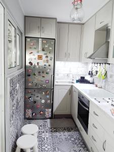 a kitchen with a refrigerator with lots of magnets at You can almost smell the sea! in Athens