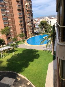 a view of a swimming pool from the balcony of a building at BE LUXURY APARTMENT 20 MTS FROM THE BEACH in Benidorm