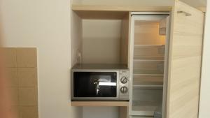 a microwave sitting on a shelf in a closet at Podmartine in Baška