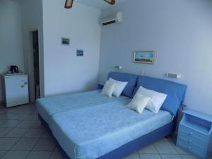 a blue bed with white pillows in a room at Margarita Karidi in Apollonia