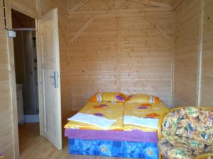 a small bedroom with a bed and a chair at Prague Retro Challenge and Garden in Prague