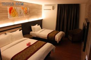 En eller flere senger på et rom på Hotel Time Boutique Nilai