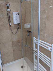 a bathroom with a shower with a glass door at Creek View in Wootton Bridge