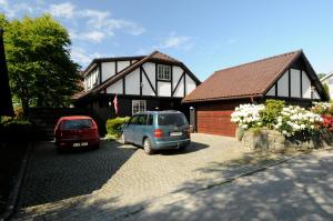 a house with a car parked in front of it at Hinna Garden in Stavanger