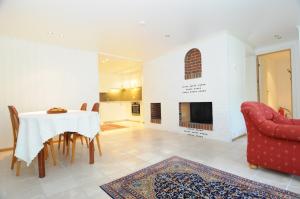 a dining room with a table and a fireplace at Hinna Garden in Stavanger
