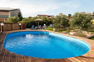 a large blue swimming pool on a wooden deck at Ktima Nikolaos in Arónion