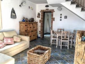 a living room with a couch and a table at Il Sogno Tanca Piras in Nebida