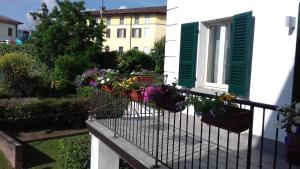 a balcony with potted plants on a house at Molino Antico in Soncino