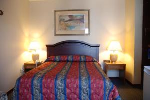 a hotel room with two beds and a lamp at Commons Inn in Halifax