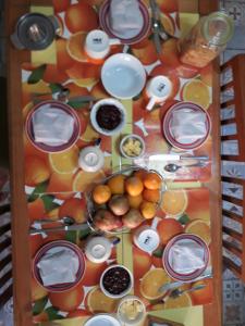 a table with plates and bowls of fruit on it at La Casa Piola in Valparaíso