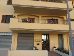 a house with a balcony and a door at Mansardina Sassu in Alghero