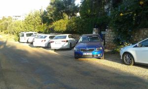 a row of cars parked on the side of a road at Miramar Pansiyon in Kaş